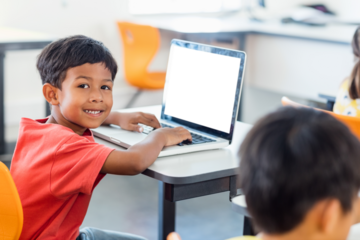 Smiling boy using laptop