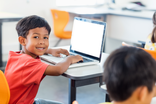 Smiling boy using laptop