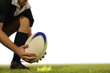 Male rugby player placing rugby ball on a stand in the stadium