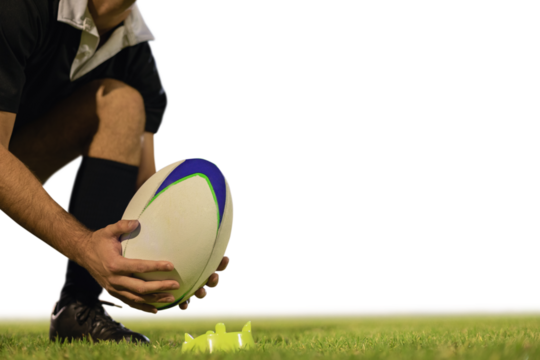 Male rugby player placing rugby ball on a stand in the stadium