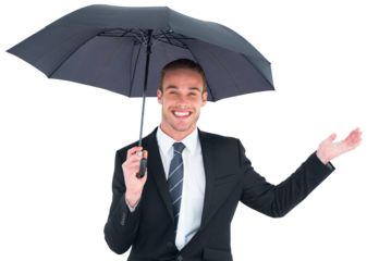 Businessman sheltering under black umbrella