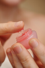 Woman applying sleep pink lip sleeping mask