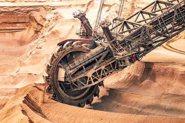 Large bucket wheel excavator mining machine at work in a brown coal open pit mine