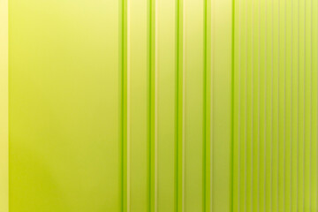 A fragment of a bright lime-colored wall with moldings. Modern trends in interior design and decoration. Space for text.