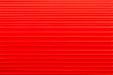 Bright red closed horizontal blinds. Close-up. Modern trends in interior decoration. Front view. Space for text.