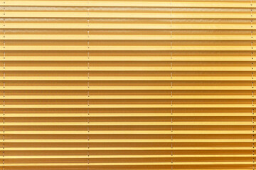 Bright yellow closed horizontal blinds. Close-up. Modern trends in interior decoration. Front view. Space for text.