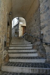 A narrow street among the old houses of Torre Cajetani, a medieval town in the province of Frosinone in Italy.