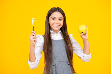 Teen girl hold toothbrush, childhood happiness, morning routine. Apple vitamins for healthy teeth. Brush teeth, dental health and oral care. Child brush her teeth.