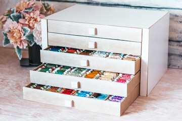 Beautiful box for threads with compartments. Beautiful colored threads in a box