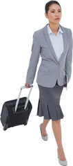 Serious businesswoman carrying her suitcase