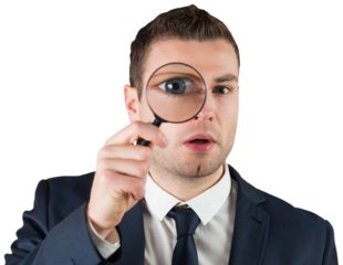 Businessman looking through magnifying glass