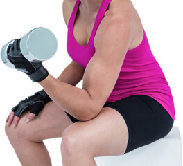 Muscular woman exercising with dumbbells 