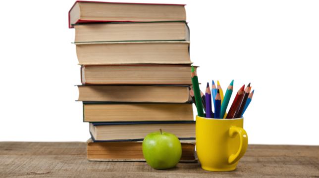Stack of books by colored pencils in mug and apple on table