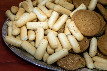 Appetizing cookies of different tastes and shapes close-up on metal tray on the table