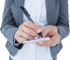 Midsection of businesswoman writing on notepad