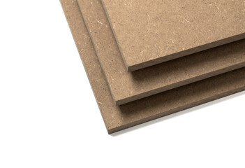 Raw brown mdf stacked on top of each other, ready for industrial use.