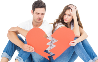 Young couple sitting on floor with broken heart shape paper