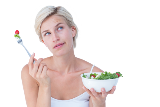 Thoughtful blonde eating salad