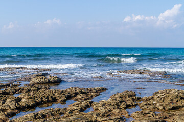 Sea low tide on the Mediterranean coast, exposing brown rocks