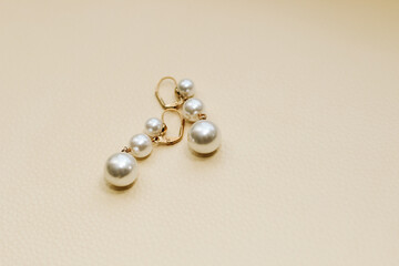 Gold ornaments from yellow metal on a light background.