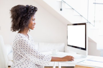 Happy woman using desktop computer
