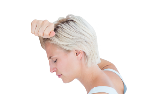 Sad blonde woman with her head on wall