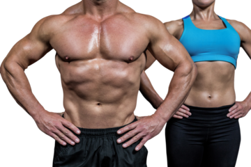 Midsection of muscular man and woman standing with hands on hip