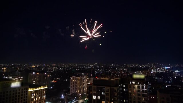 Beautiful night city of Bishkek with buildings and cars and fireworks