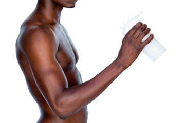 Mid section of a sporty young man holding protein drink