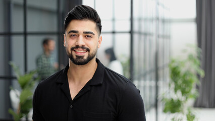 Confident young businessman posing in the office