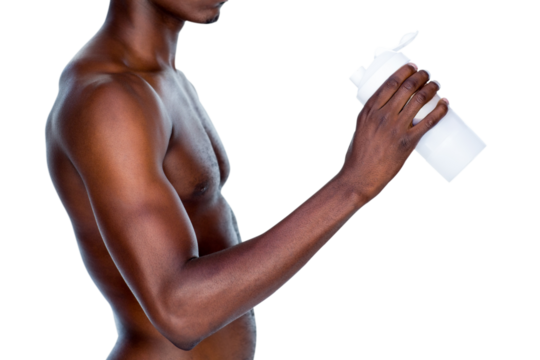 Mid section of a sporty young man holding protein drink