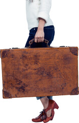 Low section of woman carrying vintage luggage 