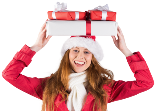 Festive redhead holding pile of gifts