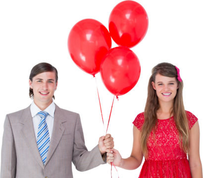 Smiling geeky couple holding red balloons