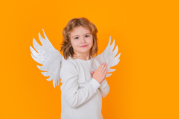 Little angel. Portrait of cute kid with angel wings isolated on studio background. Little angel, valentines day. Angelic kids.