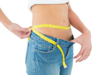Mid section of woman measuring waist in a big sized jeans