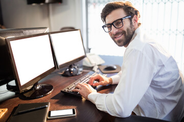 Portrait of creative businessman using computer