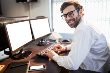 Portrait of creative businessman using computer