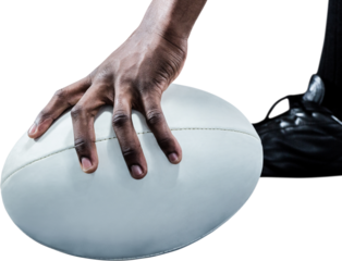 Cropped image of sportsman holding rugby ball