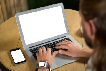 Cropped image of man using laptop