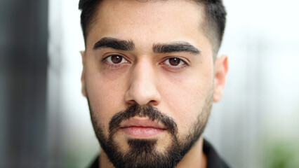 Fototapeta premium Close-up portrait of a confident businessman, against the backdrop of a modern office