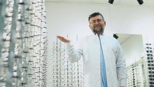 Senior dotor ophthalmologist in glasses in optical store. Ophthalmology, excellent vision or optician shop concept