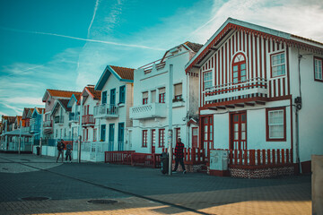 Aveiro, Portugal - 2023: Costa Nova do Prado typical beach houses with stripes of multiple colors. Touristic destination for people to take photos. Late at the afternoon in summertime.