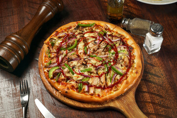 Grilled Chicken BBQ Pizza isolated on cutting board top view on table italian fastfood