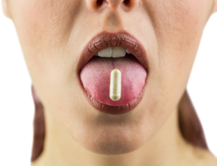 Close-up of woman with pill on tongue
