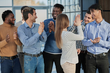 Human resources. Group portrait of smiling employees of a friendly team of different racial genders standing together in an office.