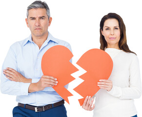 Portrait of couple holding broken heart shape paper