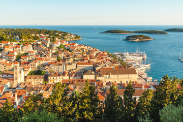 Obraz premium Aerial view of the old town of Hvar with turquoise water bay with yachts and islands in Dalmatia, Croatia and Adriatic sea