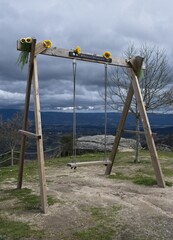 Wonderful landscapes in Portugal. Beautiful scenery of Miradouro dos Contrabandistas in Ervededo. Baloico Sao Caetano. Swing at the viewpoint. Cloudy spring day. Selective focus