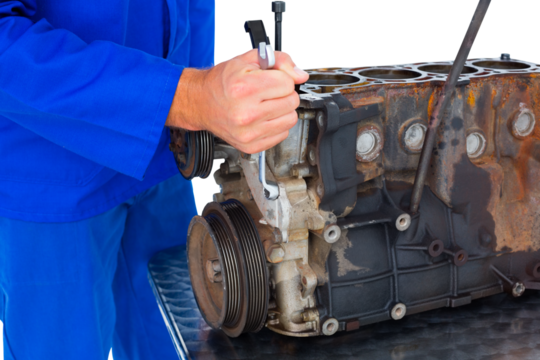 Male mechanic repairing car engine